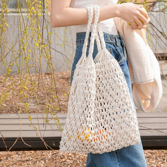 Model carrying a white cotton tote bag in hand, easy for commuting and weekends.
