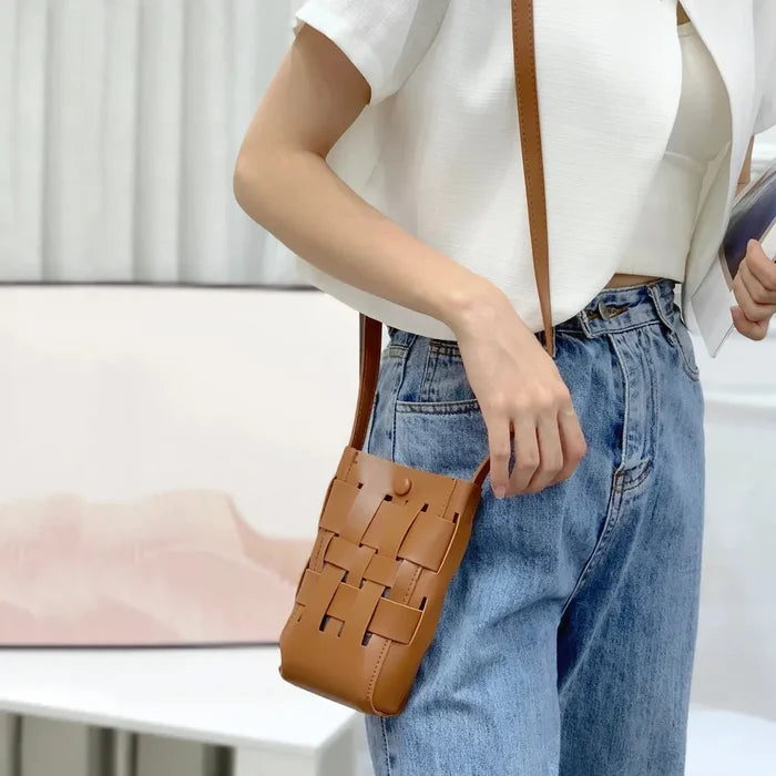 Model carrying a tan Hollow Design Woven Leather Crossbody Bag on shoulder , easy for commuting and weekends.