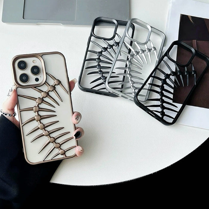 White silicone iPhone case with gold hollow fishbone. Display showing three other cases in black and silver.