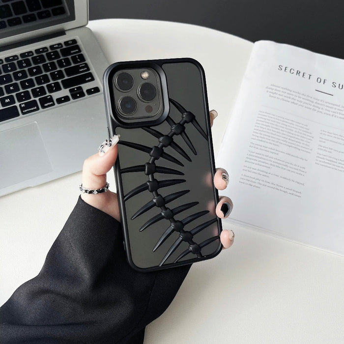 Model holding Hollow Fishbone Phone Case in matte black. Artistic silicone & faux leather hollow design.