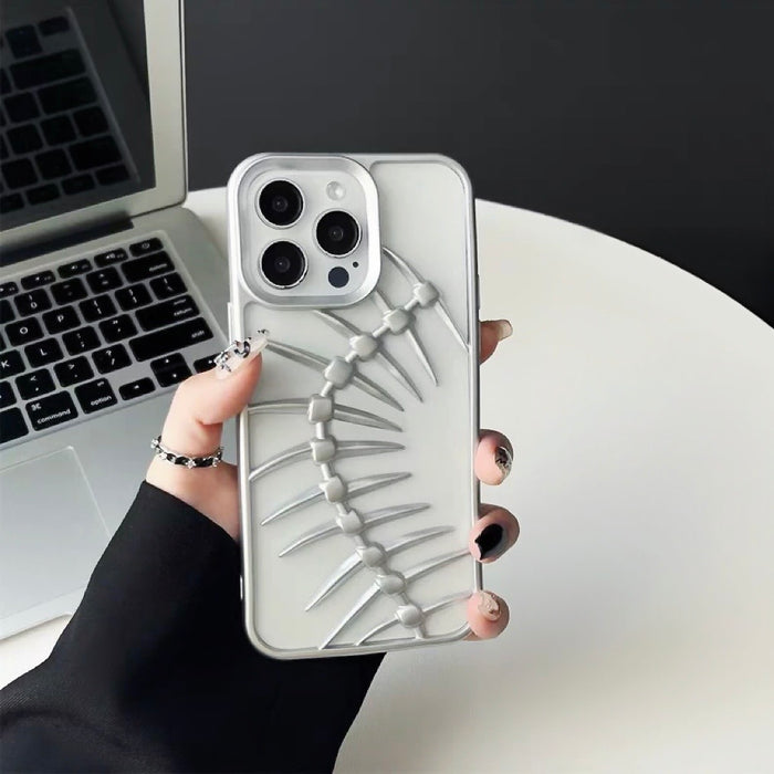 Model holding Hollow Fishbone Phone Case in matte silver. Premium skeletal design for a techwear aesthetic.