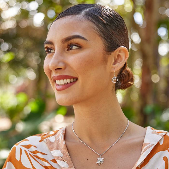 Smiling woman in a garden wearing Honu Pendant / Charm in Sterling Silver and Wave earrings