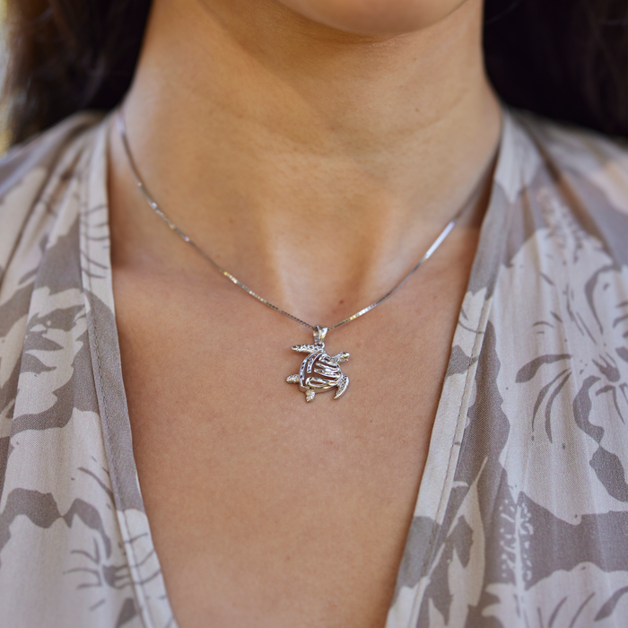 Close up of Honu Pendant in Sterling Silver on a personʻs neck