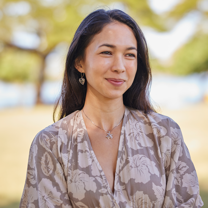 Woman in a park wearing a Honu Pendant in Sterling Silver