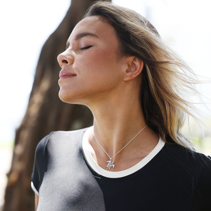 Woman outdoors wearing a Honu Pendant in Sterling Silver