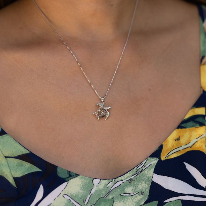 Close up of Honu Pendant in Sterling Silver on a personʻs chest