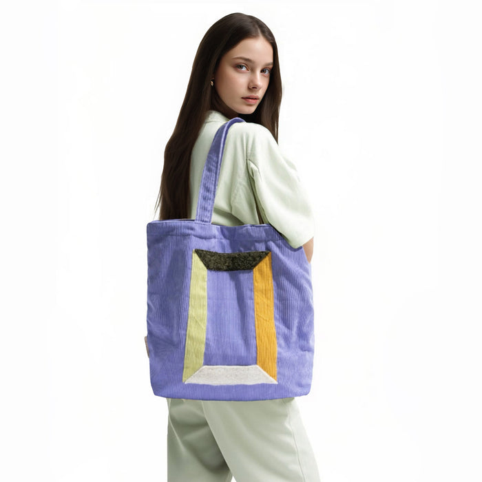 Model carrying a Hued Panel Corduroy Tote Bag, easy for commuting and weekends.