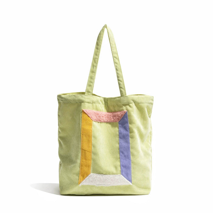 Flat lay of Hued Panel Corduroy Tote Bag, great for everyday carry and travel.