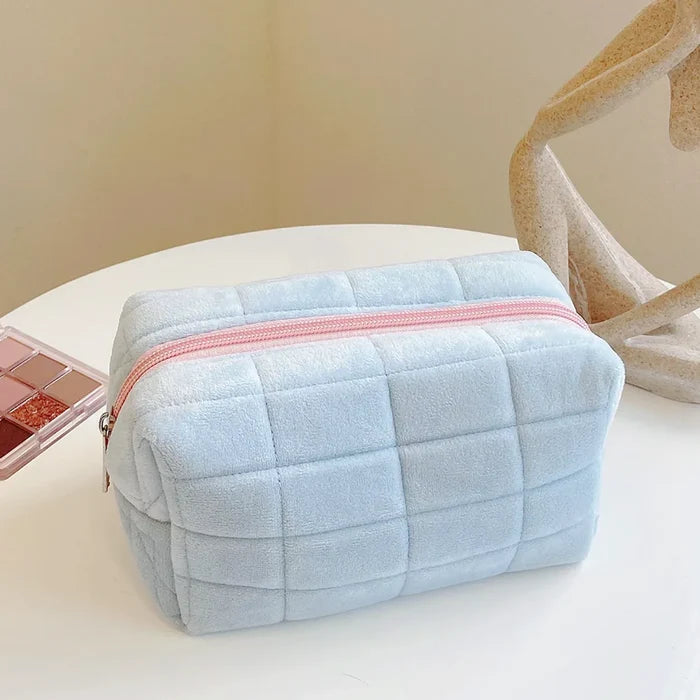 Flat lay of Icecream Makeup Bag in blue, ideal for travel makeup and toiletries.