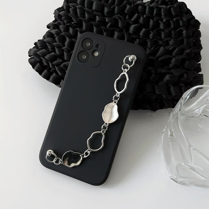 Black silicone case with a silver irregular metal chain wrist strap. Stylish urban techwear accessory.