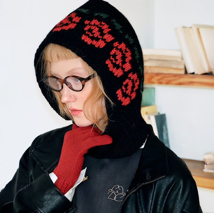 Black jacquard knitted balaclava with red and green geometric patterns, providing comprehensive cold-weather protection.