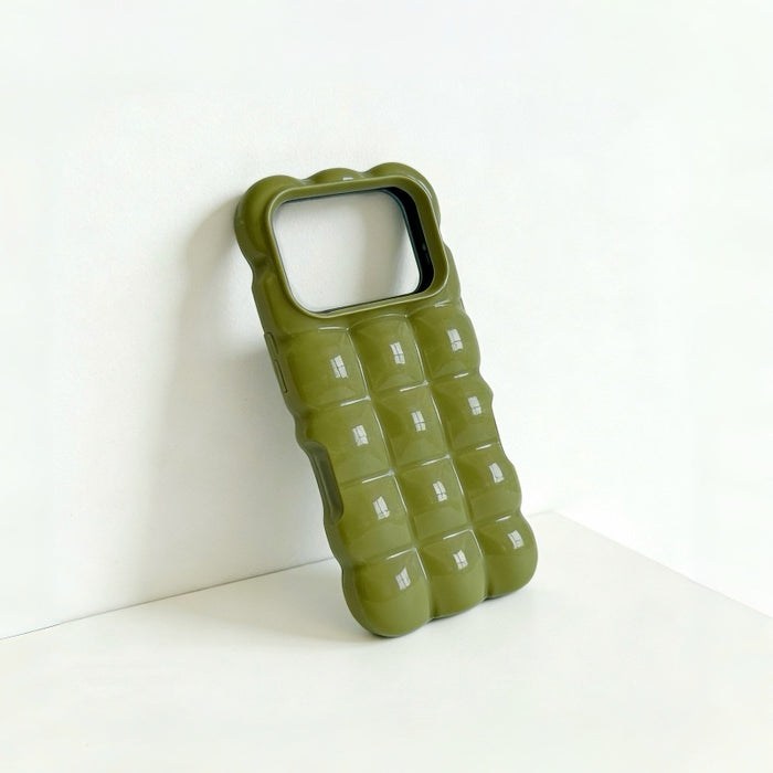 Close-up of a green jelly case with a glossy 3D bubble texture.