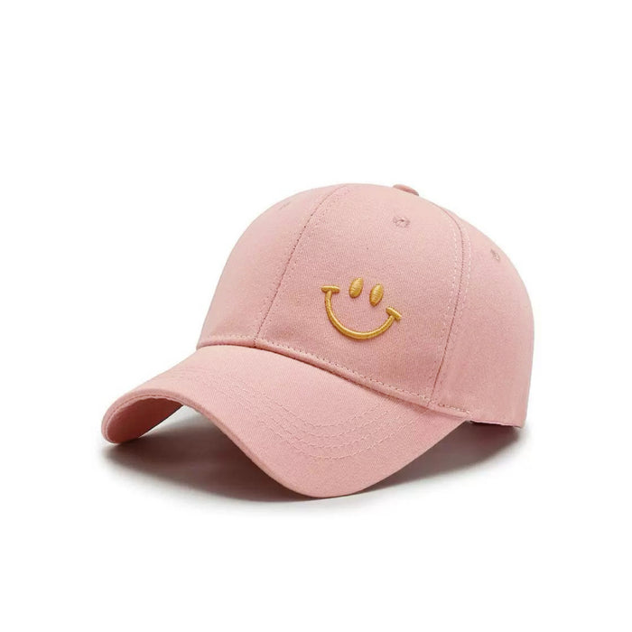 Front view of Joyful Grin Cap in pink, displays iconic smile graphic for a vibrant and trendy summer headwear choice.