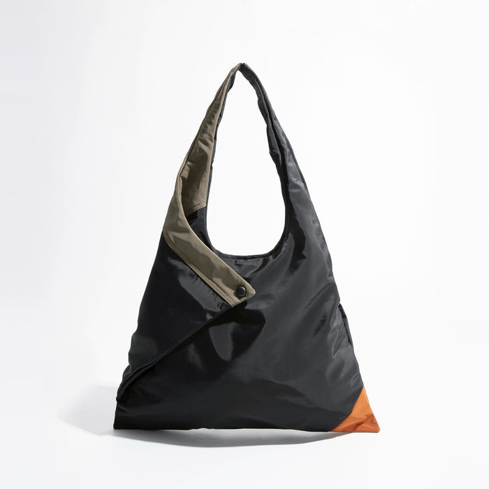 Front view of the Jungle Triangle Tote bag showing the black nylon exterior and olive green handle detail.