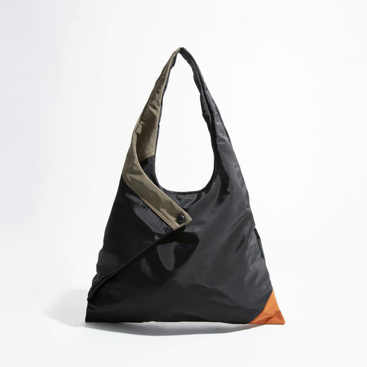 Front view of the Jungle Triangle Tote bag showing the black nylon exterior and olive green handle detail.