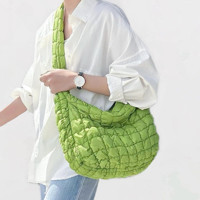 Model wearing the vibrant large green puffy crossbody bag for a casual modern look。