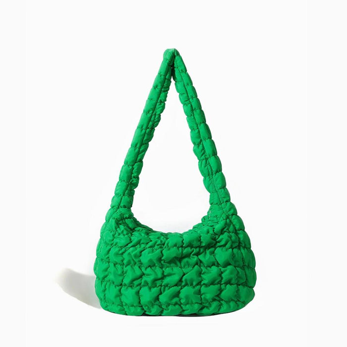 Isolated front view of the green puffy quilted crossbody bag.