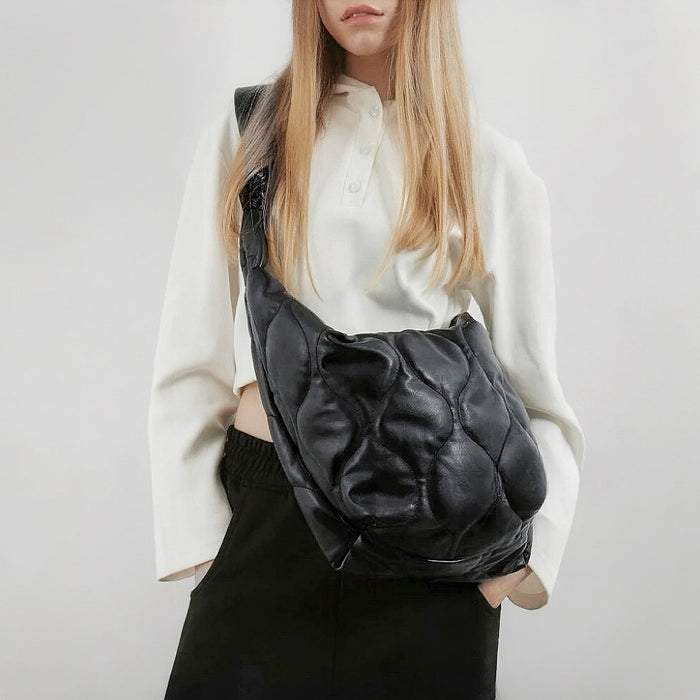 Model carrying a black nylon crossbody bag as crossbody, great for daily carry and travel.