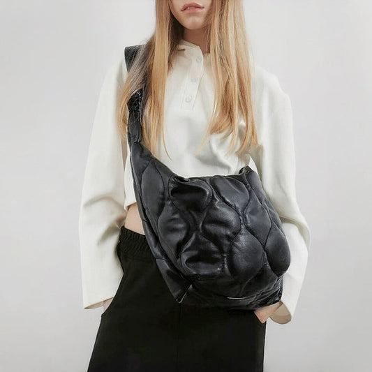 Model carrying a black nylon crossbody bag as crossbody, great for daily carry and travel.