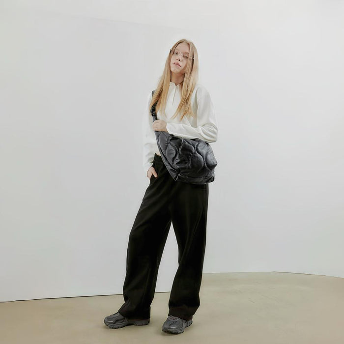 Model carrying a Large Quilted Slouchy Bag as crossbody in black, easy for commuting and weekends.