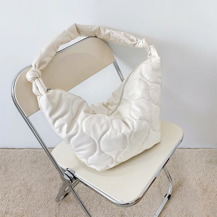 Flat lay of Large Quilted Slouchy Bag in white, great for everyday carry and travel.