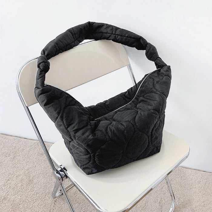 Folded view of Large Quilted Slouchy Bag in black, easy for commuting and weekends.