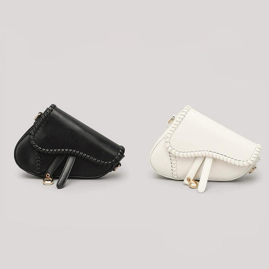 Two colors of Leather Threaded Saddle Bag shown together,  one black and one white.
