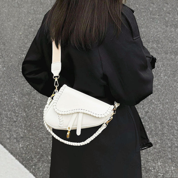 Model carrying a Threaded Saddle Bag in white as crossbody, ideal for city walks and gifting.