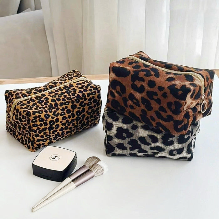 Angled view of three Leopard Allure Makeup Bags, great for on-the-go touch-ups.
