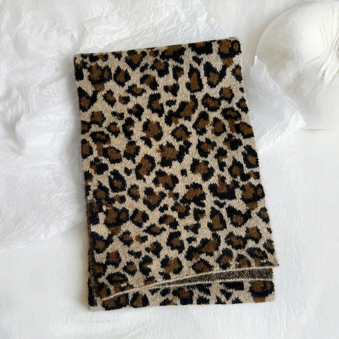 Flat lay of Leopard Print Knit Scarf, great for office layering and commuting.