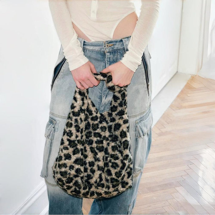 Model carrying a khaki leopard print polyester tote bag handheld, great for daily carry and travel.