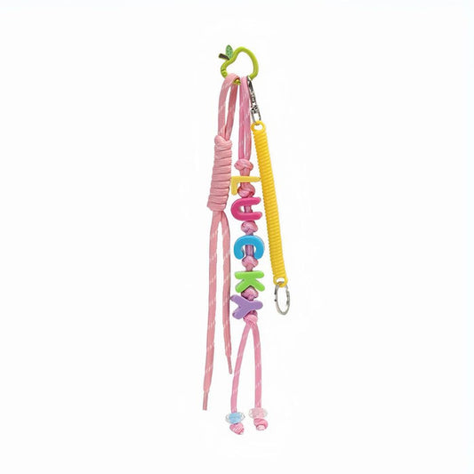 Front view of Pink polyester bag charm with colorful LUCKY letters, pink ropes and a green spring.