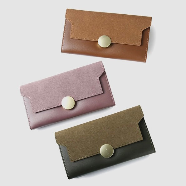 Flat lay showing three wallets in green, pink, brown, great for everyday carry and travel.