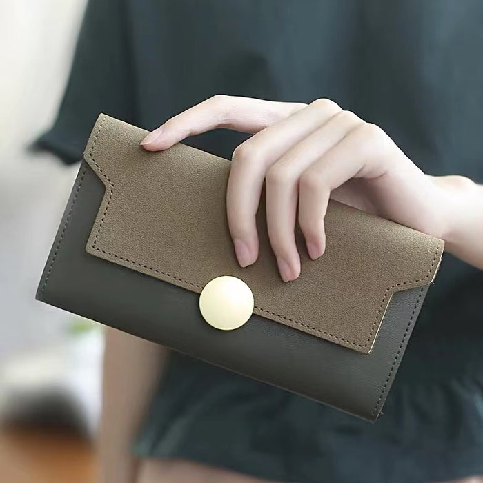 Model holding Long Wallet With Nubuck Leather Flap in green, easy for everyday use and errands.