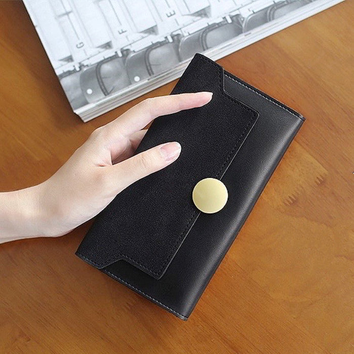 Model holding Long Wallet With Nubuck Leather Flap in black, great for daily carry and travel.