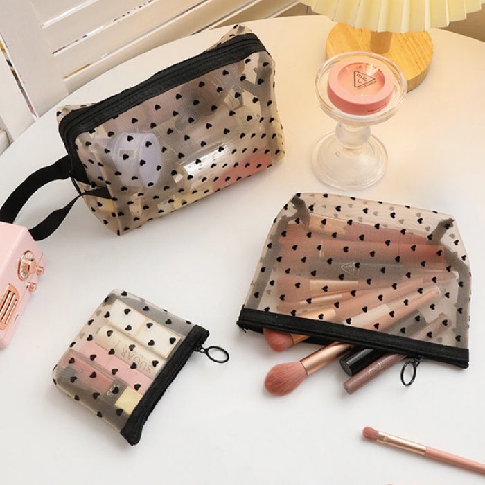 Three sizes of sheer black organza makeup bags with heart prints; aesthetic mesh cosmetic organizers.