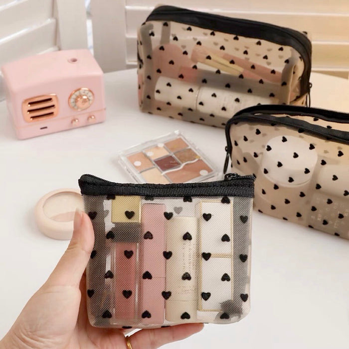 Model holding a small heart print organza pouch; showing the delicate sheer texture and high-clarity mesh.
