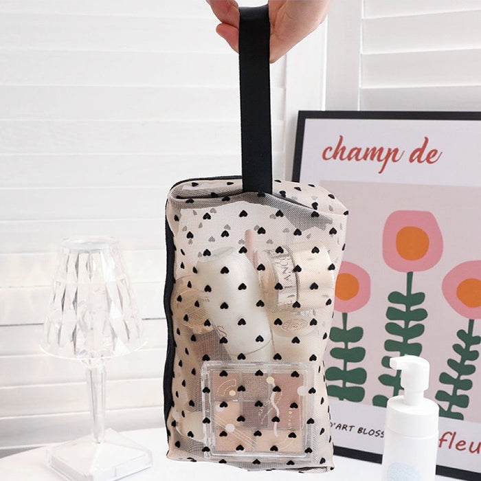 Side view of organza pouch showing the convenient carrying strap and smooth zipper detail.