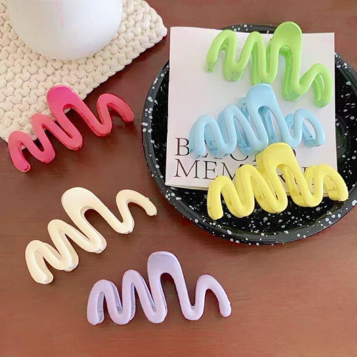 Set of six colorful acrylic Macaron Wave Hair Claws in rose, light green, purple, blue, yellow, cream.