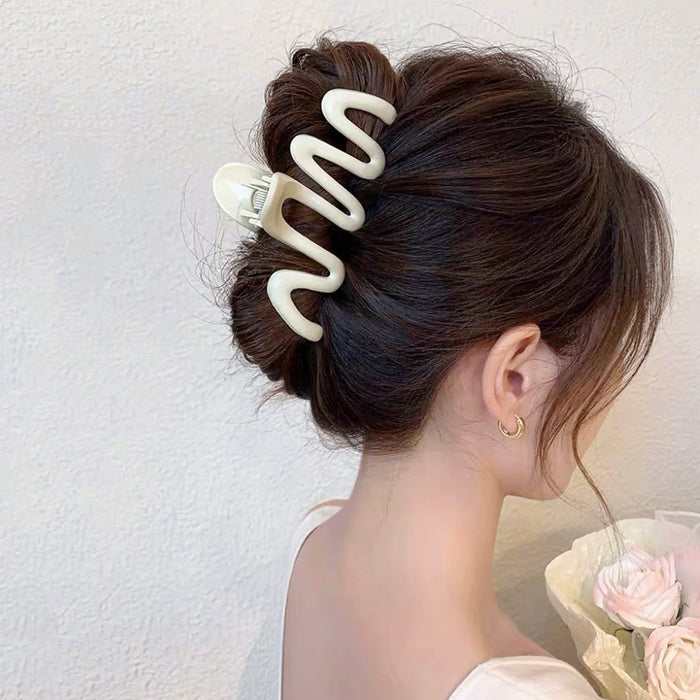 Model wearing Macaron Wave Hair Claw in cream white, ideal for quick updos and ponytails.