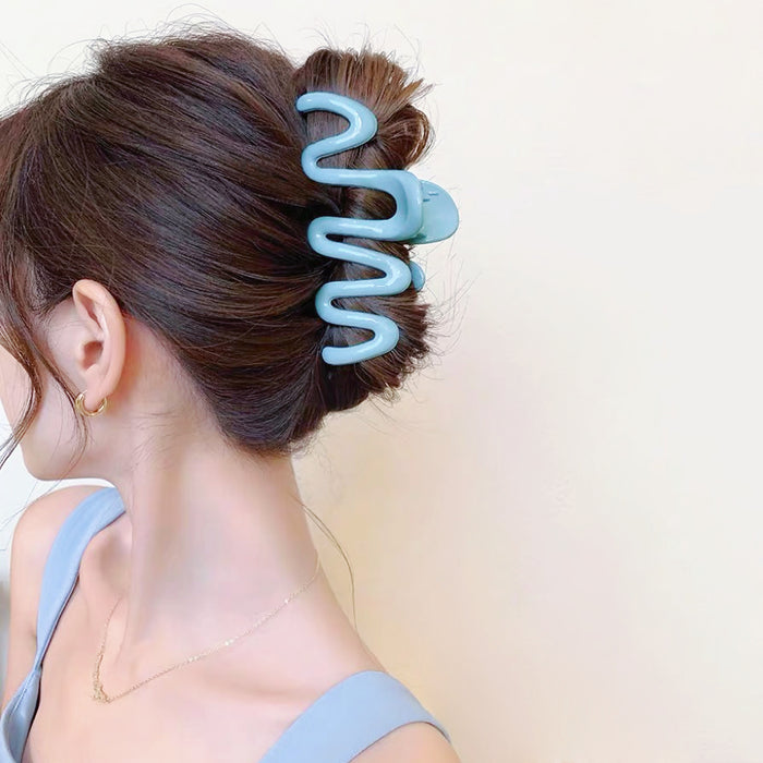 Model wearing  Macaron Wave Hair Claw in blue, easy for workdays and special occasions.