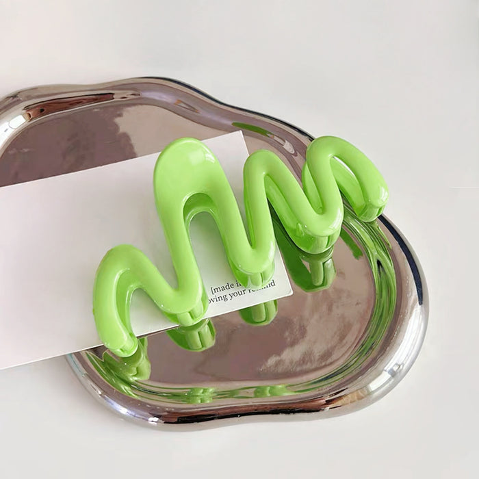 Flat lay of Macaron Wave Hair Claw  in green, great for everyday styling and gifting.