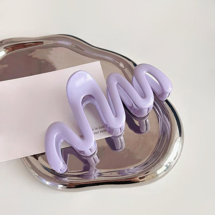 Angled view of Macaron Wave Hair Claw  in purple, great for everyday styling and gifting.