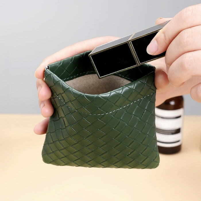 Hands opening green magnetic self-closing storage bag; woven-look pouch for quick makeup storage on the go.