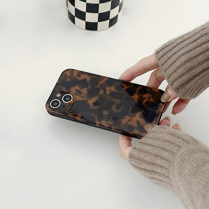 Model holding Maillard Amber Case. Sophisticated translucent finish for a polished and professional look.