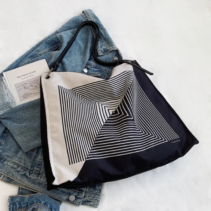 Monochrome geometric nylon bag showing the sturdy straps and smooth texture.