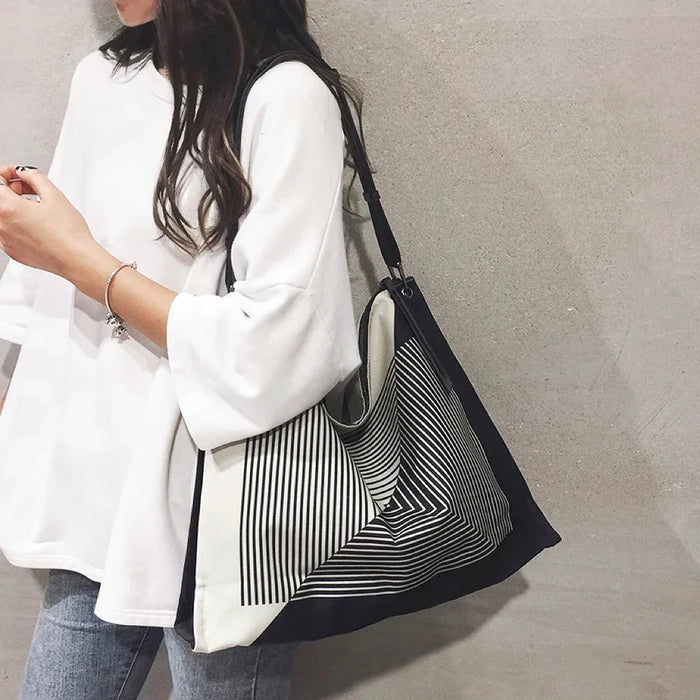Mode wearing a maze print nylon tote on shoulder, showing  a casual style.