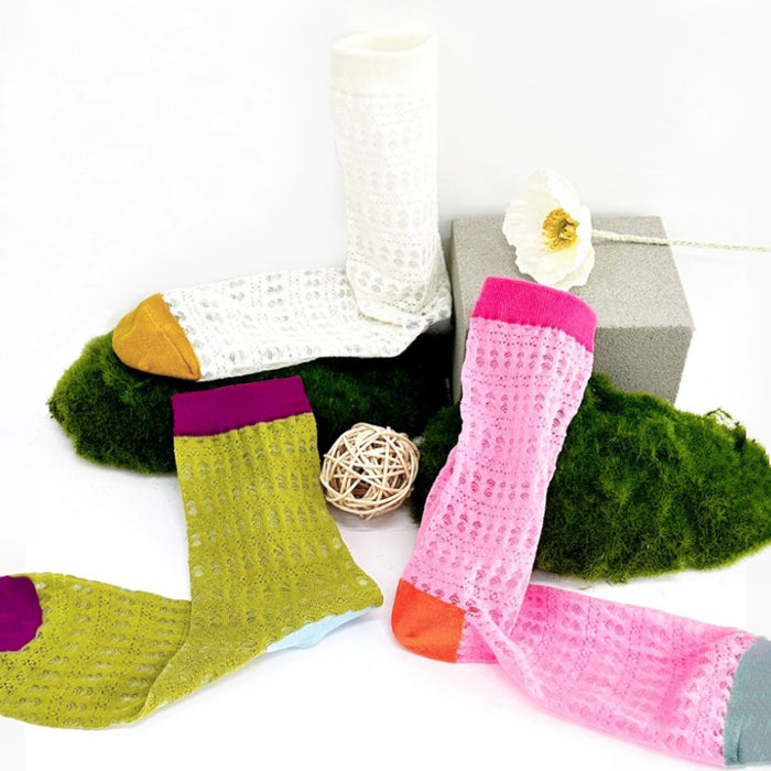 Front view of Three pairs of mesh gauze colored socks: white, green and pink.