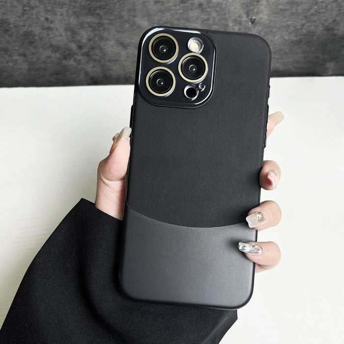 Black metal and PU leather case for iPhone with gold camera accents. Cyber-chic industrial style.