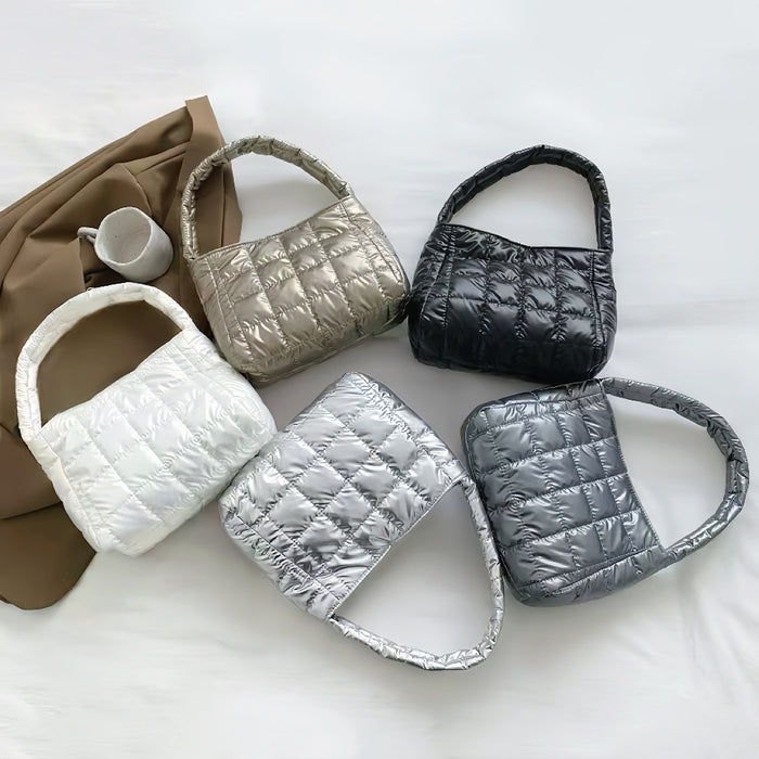 Front view of Five metallic quilted polyester bags in white, silver, gold, black, and dark gray.